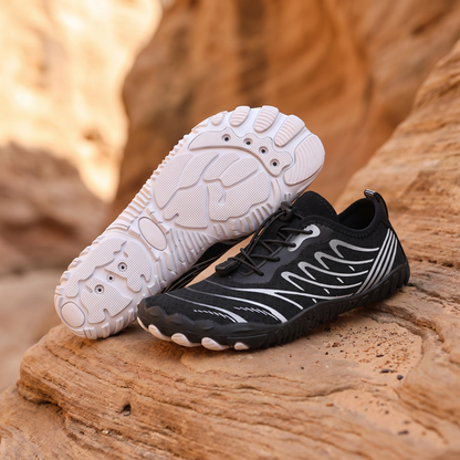 Black and White water trekking shoes on warm sandstone rock